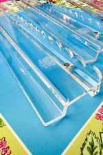 Clear acrylic racks and pushers with etched Bird Bam Tiles logo on colorful mahjong mat background