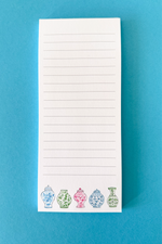 Lined notepad with ginger jar designs from the Sweet Carolina Tile Set at the bottom of the paper on a blue background