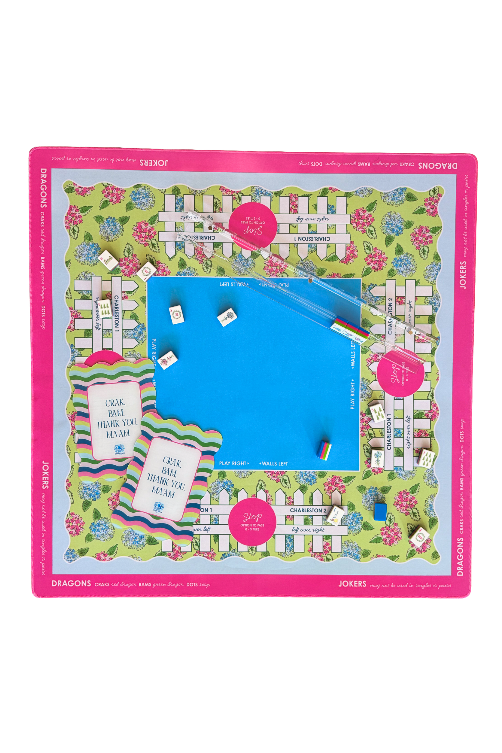 Colorful mahjong mat with shuffler cards, tiles, and acrylic racks and pushers on it