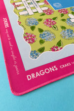 Details of a colorful Mahjong mat with floral design and text on a blue background